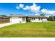 Attractive single-level house with a tidy front lawn, attached garage, and a welcoming front entrance at 3085 Crowder St, Punta Gorda, FL 33980