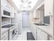 Clean and bright kitchen featuring white cabinets, appliances, and tile flooring, maximizing space and functionality at 3085 Crowder St, Punta Gorda, FL 33980
