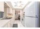 Functional kitchen with white appliances, tile flooring, and a view into the adjacent dining area, creating an open feel at 3085 Crowder St, Punta Gorda, FL 33980