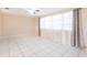 Bright living room featuring white tile floors, large windows, and neutral walls at 3085 Crowder St, Punta Gorda, FL 33980