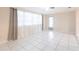 Bright living room featuring white tile floors, large windows, and access to the patio at 3085 Crowder St, Punta Gorda, FL 33980