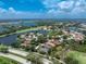 Panoramic aerial view of the community with surrounding lakes and golf course at 3207 Village Ln, Port Charlotte, FL 33953