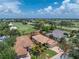 Beautiful aerial view of the home, golf course, and surrounding community at 3207 Village Ln, Port Charlotte, FL 33953