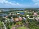 Aerial view showcasing proximity to golf course and neighborhood lakes at 3207 Village Ln, Port Charlotte, FL 33953