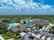 Aerial view of the community clubhouse, pool and surrounding area at 3207 Village Ln, Port Charlotte, FL 33953