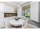 Bright breakfast nook features a round table, ample storage, and natural light from a large window at 3207 Village Ln, Port Charlotte, FL 33953