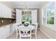 Cozy breakfast nook with white table, cabinetry, and window views of the exterior at 3207 Village Ln, Port Charlotte, FL 33953