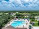An aerial shot of the large community pool with ample seating and lush tropical landscaping at 3207 Village Ln, Port Charlotte, FL 33953