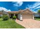 Well maintained exterior showing a paved drive and manicured lawn at 3207 Village Ln, Port Charlotte, FL 33953