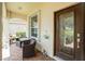 Charming front porch area with comfortable seating and a view, offering a relaxing outdoor space at 3207 Village Ln, Port Charlotte, FL 33953