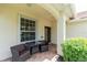 Cozy front porch with a table and chairs, perfect for enjoying the outdoors at 3207 Village Ln, Port Charlotte, FL 33953