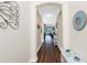 Spacious hallway with wood floors leading into an open-concept living area at 3207 Village Ln, Port Charlotte, FL 33953