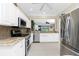 Modern kitchen featuring stainless steel appliances, white cabinetry, and granite countertops at 3207 Village Ln, Port Charlotte, FL 33953