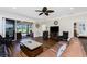 Large living room with hardwood floors, fan, and sliding glass doors leading to outdoor patio at 3207 Village Ln, Port Charlotte, FL 33953