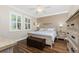 Relaxing main bedroom with wood floors, ceiling fan, large window, and dresser at 3207 Village Ln, Port Charlotte, FL 33953