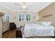Inviting main bedroom boasts a wood floors, ceiling fan, and windows providing ample natural light at 3207 Village Ln, Port Charlotte, FL 33953