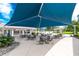 Outdoor seating area under the large blue canopy at 3207 Village Ln, Port Charlotte, FL 33953