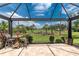 Spacious screened-in patio with great golf course views, and comfortable seating at 3207 Village Ln, Port Charlotte, FL 33953