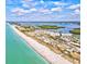 Expansive aerial view of a beach, coastline and surrounding buildings and parking at 34 Broadmoor Ln, Rotonda West, FL 33947