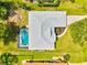 Aerial view of a well-maintained home with a pool, lush lawn, and a new roof in a desirable neighborhood at 34 Broadmoor Ln, Rotonda West, FL 33947
