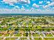 Aerial shot of a community with waterfront homes, green lawns, and lush landscaping near a lake at 34 Broadmoor Ln, Rotonda West, FL 33947