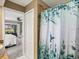 View from the bathroom with a shower and a shower curtain leading to the main bedroom at 34 Broadmoor Ln, Rotonda West, FL 33947