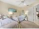 Bright bedroom with two twin beds, a window, and a ceiling fan at 34 Broadmoor Ln, Rotonda West, FL 33947