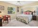Brightly lit bedroom with a ceiling fan, windows, a comfy bed, and nice decorations at 34 Broadmoor Ln, Rotonda West, FL 33947