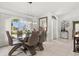 Dining room features a modern glass table, stylish chairs, and bright natural light at 34 Broadmoor Ln, Rotonda West, FL 33947