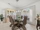 Bright dining room features contemporary lighting, modern furnishings, and ample natural light at 34 Broadmoor Ln, Rotonda West, FL 33947