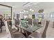 Dining area flowing to living room with a stylish glass table with modern chair designs at 34 Broadmoor Ln, Rotonda West, FL 33947