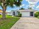 Well-maintained home with lush landscaping, a screened-in entry, and a spacious two-car garage at 34 Broadmoor Ln, Rotonda West, FL 33947