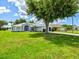 Desirable home with a manicured front lawn, landscaping, and a spacious driveway at 34 Broadmoor Ln, Rotonda West, FL 33947