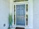 Stylish front door with sidelights and transom window enhances the entryway's curb appeal at 34 Broadmoor Ln, Rotonda West, FL 33947