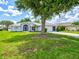 Charming home with a well-manicured lawn, mature trees, and tidy landscaping, adding to its curb appeal at 34 Broadmoor Ln, Rotonda West, FL 33947