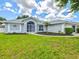 Charming single-story home with a well-maintained lawn, fresh landscaping, and inviting curb appeal at 34 Broadmoor Ln, Rotonda West, FL 33947