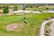 A golfer and golf cart are featured on a putting green as part of an aerial view of the course at 34 Broadmoor Ln, Rotonda West, FL 33947