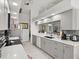 This remodeled kitchen features gray and white cabinets, stainless steel appliances, and granite counters at 34 Broadmoor Ln, Rotonda West, FL 33947