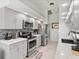 This remodeled kitchen features gray cabinets, stainless steel appliances, granite counters, and modern backsplash at 34 Broadmoor Ln, Rotonda West, FL 33947