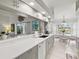 This remodeled kitchen features gray and white cabinets, stainless steel appliances, and a counter breakfast bar at 34 Broadmoor Ln, Rotonda West, FL 33947