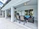 This covered lanai offers seating and dining areas with great views of the lovely green backyard at 34 Broadmoor Ln, Rotonda West, FL 33947