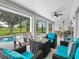 Covered lanai with comfortable seating, perfect for outdoor entertaining and relaxation overlooking the pool at 34 Broadmoor Ln, Rotonda West, FL 33947