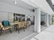 A covered lanai boasts a dining area, outdoor grill, ceiling fan and access to the sunny backyard at 34 Broadmoor Ln, Rotonda West, FL 33947