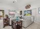 Comfortable living room with stylish decor, television, and sliding glass doors to the outside pool at 34 Broadmoor Ln, Rotonda West, FL 33947