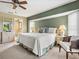 This Main bedroom features a king bed, a sitting chair and an attached bathroom suite at 34 Broadmoor Ln, Rotonda West, FL 33947