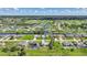 Expansive aerial view of a community with lush green lawns, a golf course, and serene waterways at 55 Mark Twain Ln, Rotonda West, FL 33947