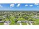 Aerial view of a lush neighborhood under blue skies at 55 Mark Twain Ln, Rotonda West, FL 33947