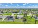 Wide aerial shot of homes with solar panels, screened-in pools, and manicured lawns near a golf course at 55 Mark Twain Ln, Rotonda West, FL 33947