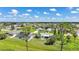 Overhead view of residences with private pools and well-maintained green spaces in a suburban neighborhood at 55 Mark Twain Ln, Rotonda West, FL 33947