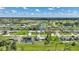 Scenic aerial view showcasing a neighborhood with canals, golf course, and beautifully landscaped homes at 55 Mark Twain Ln, Rotonda West, FL 33947